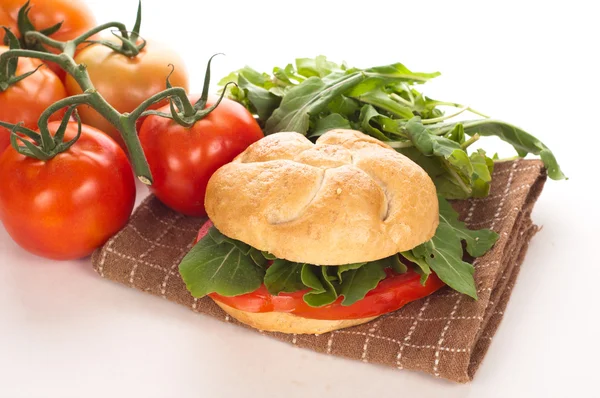 Sandwich with tomatoes and arugula — Stock Photo, Image