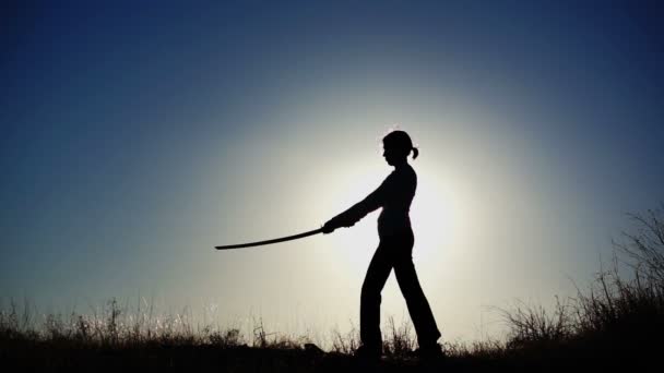 Silhouette of Girl Practicing With Sword — Stock Video