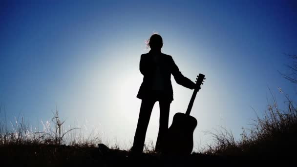 Silhouette of Girl and a Guitar — Stock Video