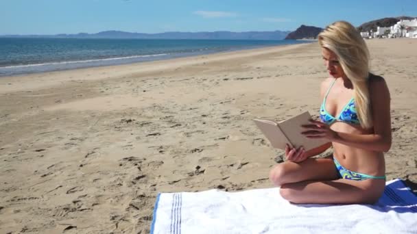 Playa Bikini chica sentarse leyendo — Vídeo de stock