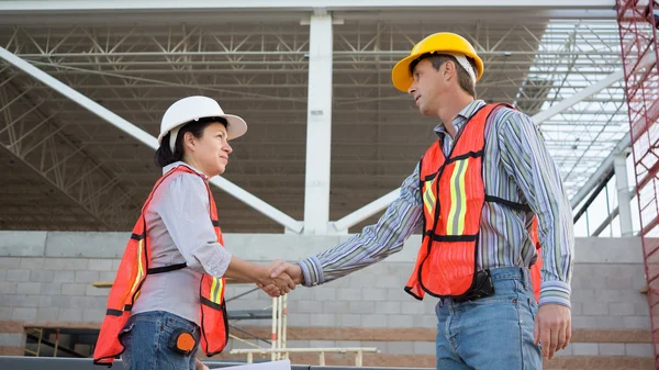 Male and Female Workers Shake Hands Royalty Free Stock Images