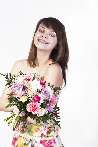 Smiling caucasian young woman with bouquet — Stock Photo, Image