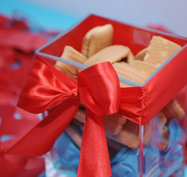 Sweet cookies in box with red bow — Stock Photo, Image