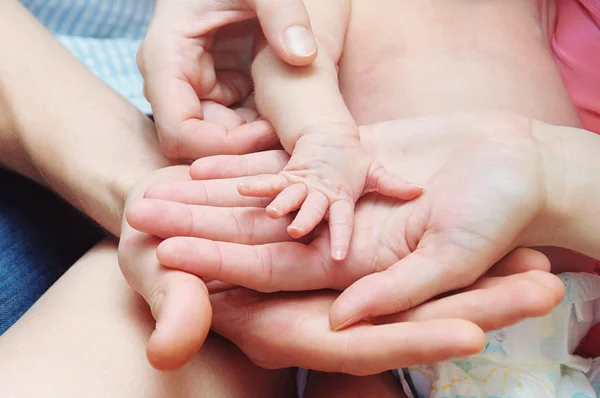A Mother and Father hold newborn baby hand — Stock Photo, Image