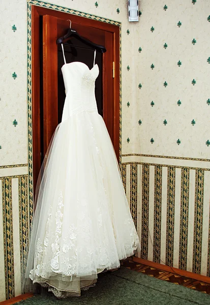 White Wedding dress hanging on a shoulders — Stock Photo, Image