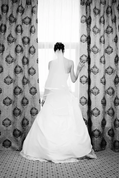 Image of beautiful bride standing at window — Stock Photo, Image