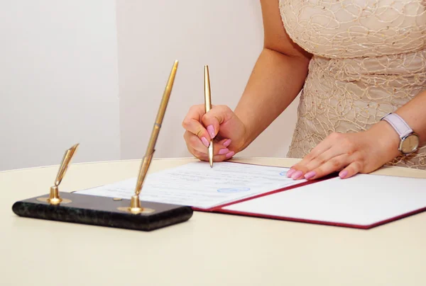 Mariée signant une licence de mariage ou un contrat de mariage — Photo