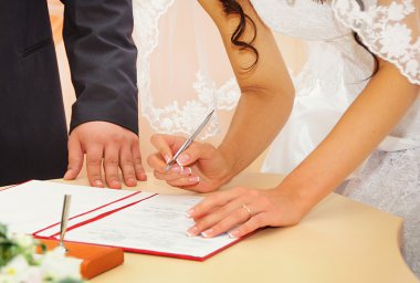 Bride signing marriage license or wedding contract clipart