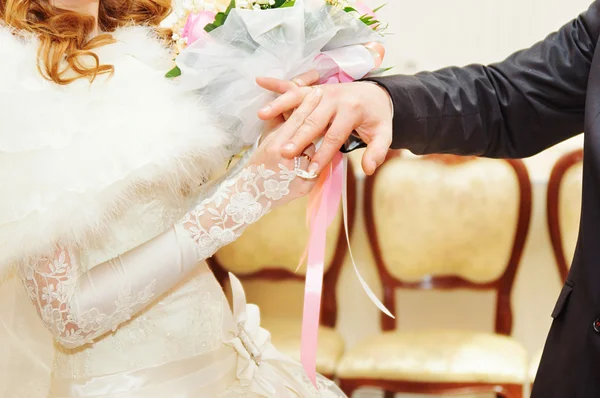 Groom putting ring on bride — Stock Photo, Image