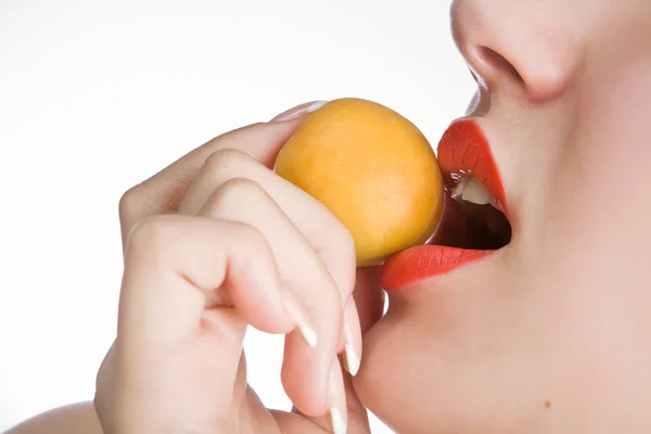 Apricot in girls lips — Stock Photo, Image