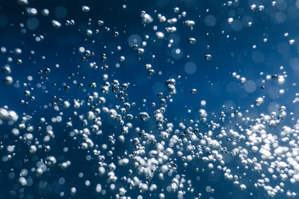 Macro bubbles of water on blue background — Stock Photo, Image