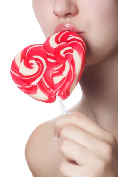 Candy red heart on the lips of a girl close up — Stock Photo, Image