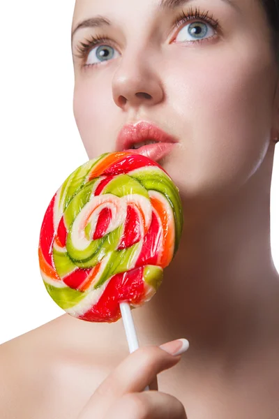 Multi-coloured candy heart on the lips of a girl close up — Stock Photo, Image