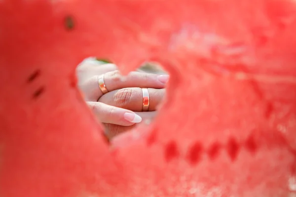 Watermelon with heart and hand with rings — Stock Photo, Image