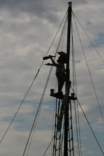 Silhouette of a pirate on the match looking through spyglass — Stock Photo, Image