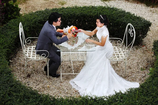 Happy couple at the banquet table on field — Stock Photo, Image