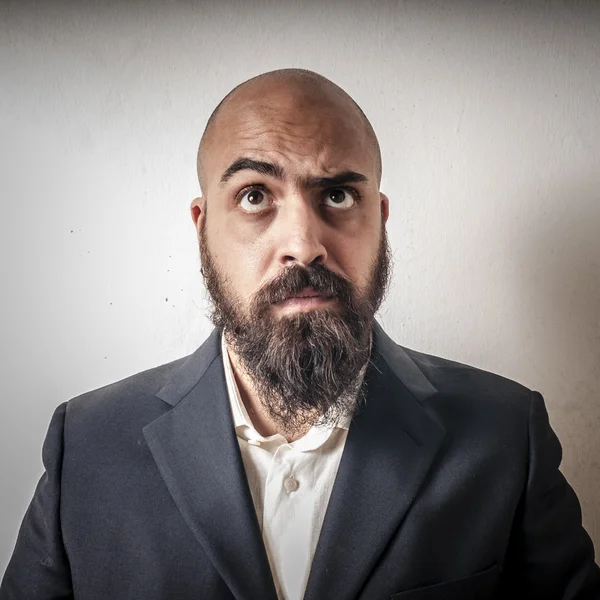 Man with a suit and beard and strange expressions — Stock Photo, Image