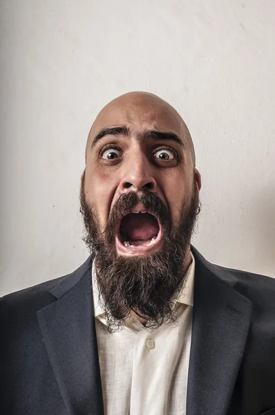 Elegant bearded man with jacket and funny expressions who cry — Stock Photo, Image