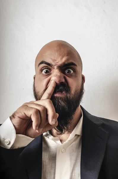 Elegant bearded man with jacket and finger in the nose — Stock Photo, Image