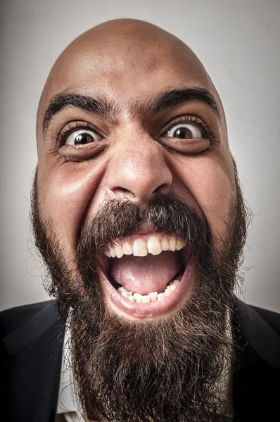 Елегантний бородатий чоловік з піджаком і кумедними виразами — стокове фото