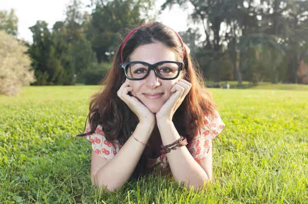 Smiling girl with big glasses at the park — Stock Photo, Image