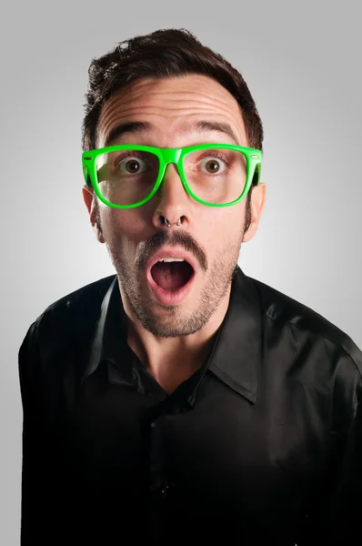 Astonished man with green eyeglasses — Stock Photo, Image