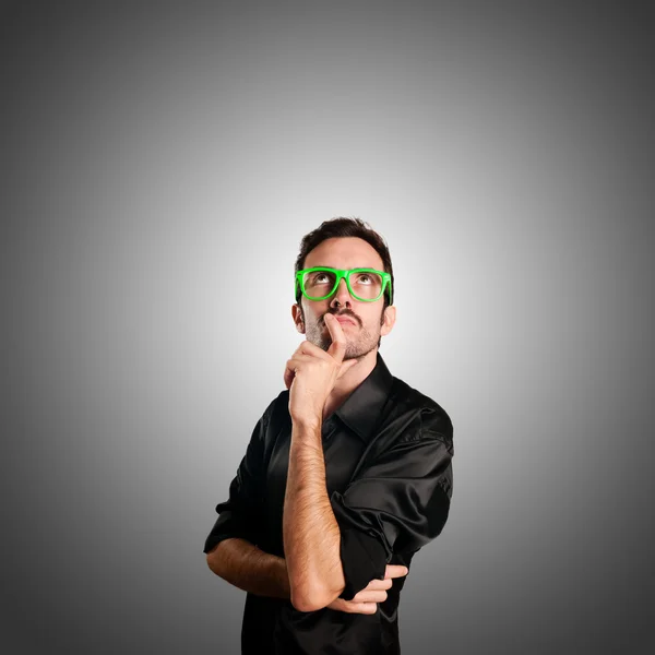 Thoughtful man with green eyeglasses — Stock Photo, Image