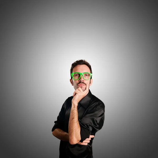 Thoughtful man with green eyeglasses — Stock Photo, Image