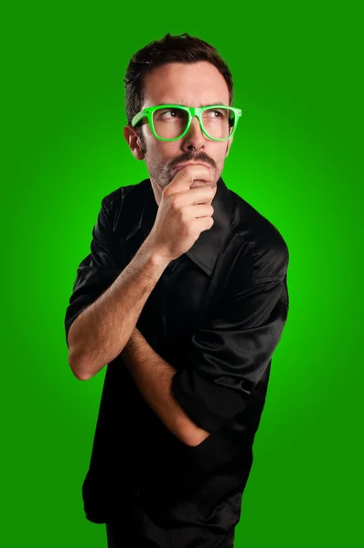 Thoughtful man with green eyeglasses — Stock Photo, Image