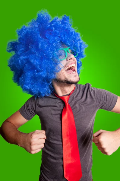 Funny dancing guy with blue wig green eyeglasses and red tie — Stock Photo, Image