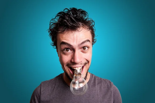 Crazy guy with bulb in his mouth — Stock Photo, Image