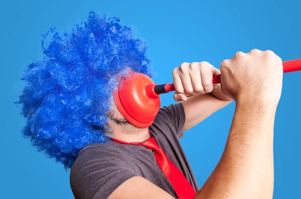 Funny guy holding red plunger in his face — Stock Photo, Image