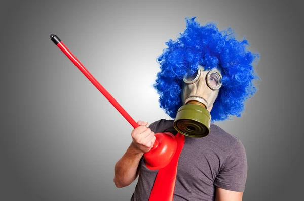 Funny guy with gas mak, blue wig and red plunger — Stock Photo, Image