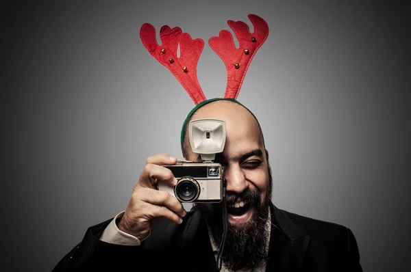 Christmas bearded man holding old camera — Stock Photo, Image