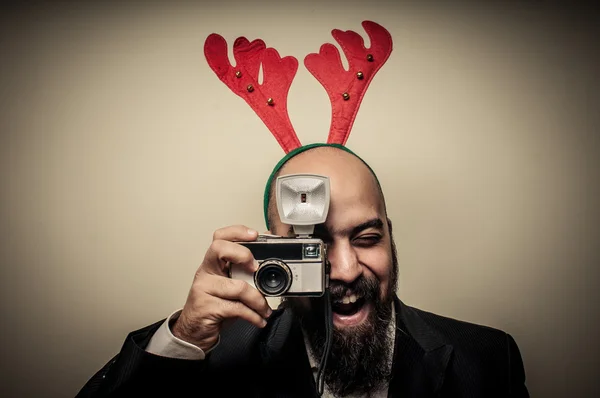 Christmas bearded man holding old camera — Stock Photo, Image