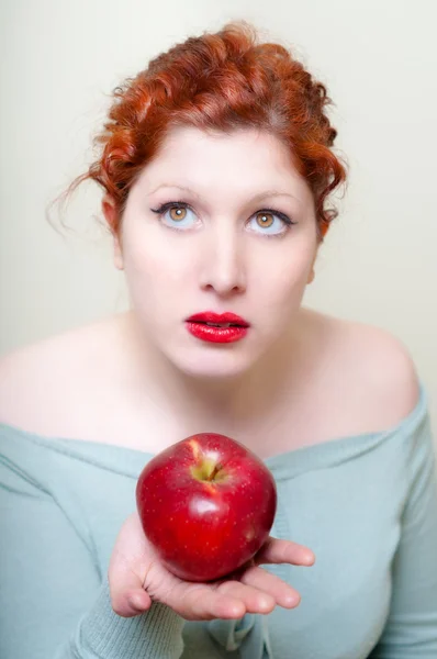 Close up portrait of girl with red hair and lips and red apple — Stock Photo, Image