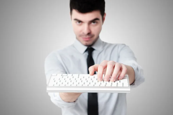 Homem de negócios segurando keybord — Fotografia de Stock