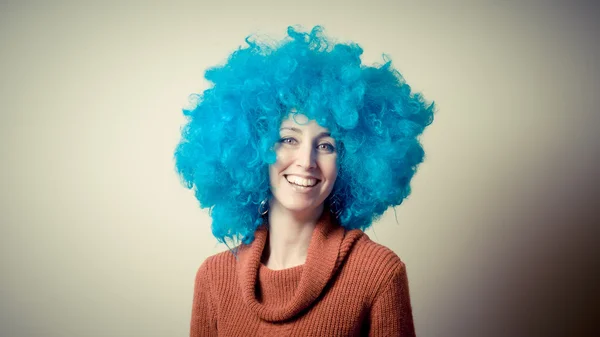 Beautiful girl with curly blue wig and turtleneck — Stock Photo, Image