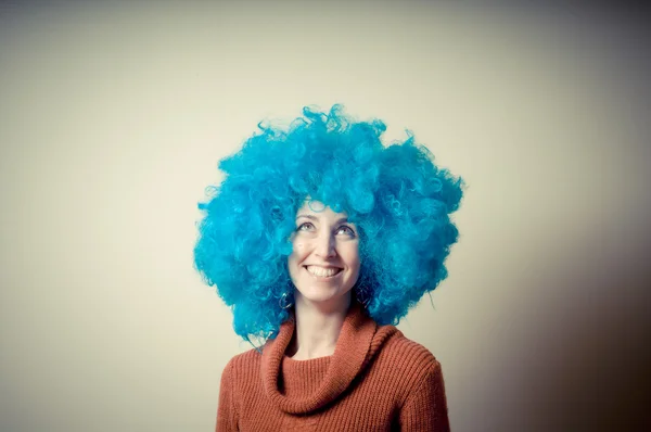 Beautiful girl with curly blue wig and turtleneck — Stock Photo, Image