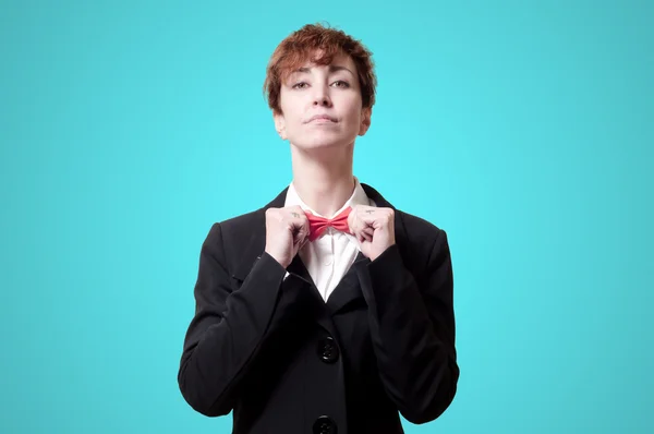 Elegant businesswoman adjusting bow tie — Stock Photo, Image