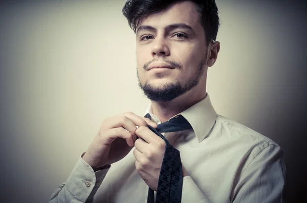 Sexy elegante hombre de negocios ajustando corbata — Foto de Stock