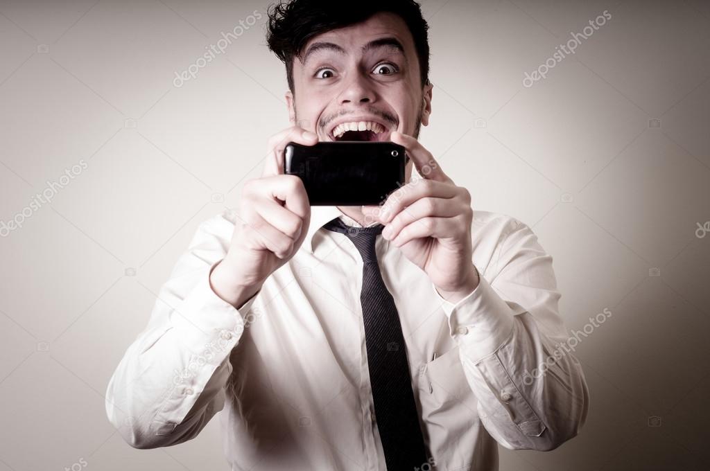 businessman taking photo with telephone