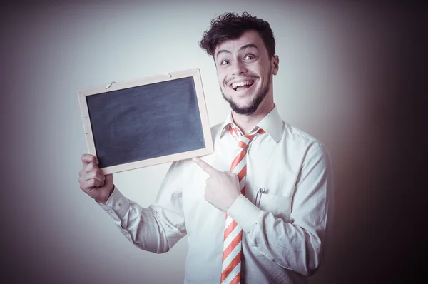 Businessman with a blank blackboard — Stock Photo, Image