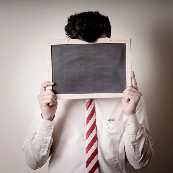 Homem de negócios com um quadro negro em branco no rosto — Fotografia de Stock