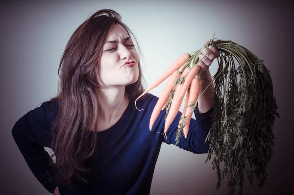 Beautiful woman with carrots — Stock Photo, Image