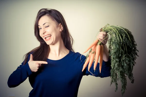 Beautiful woman with carrots — Stock Photo, Image