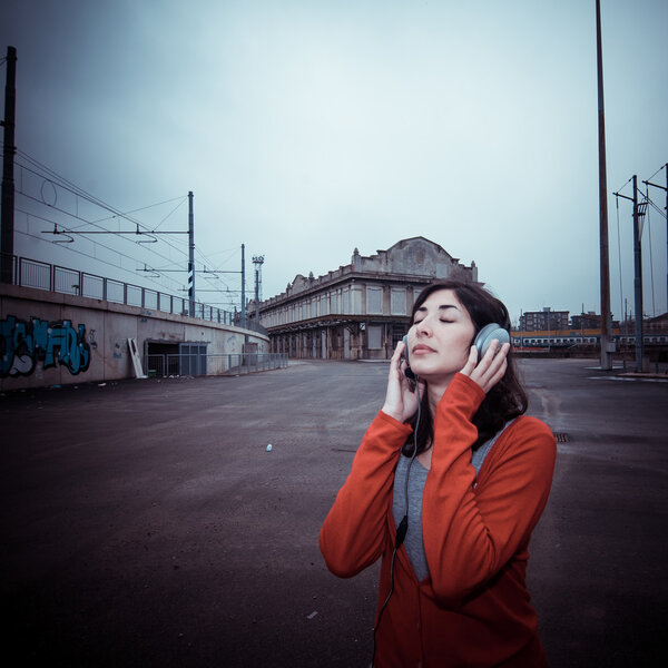 Beautiful stylish woman listening to music