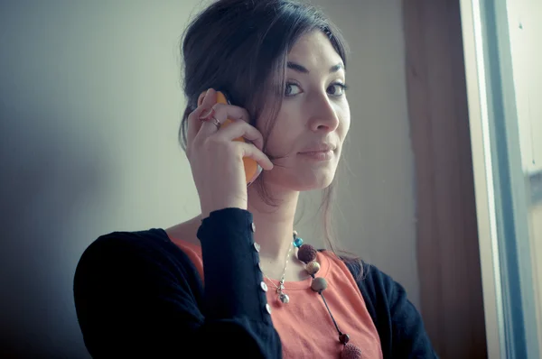 Beautiful woman at home at the phone — Stock Photo, Image