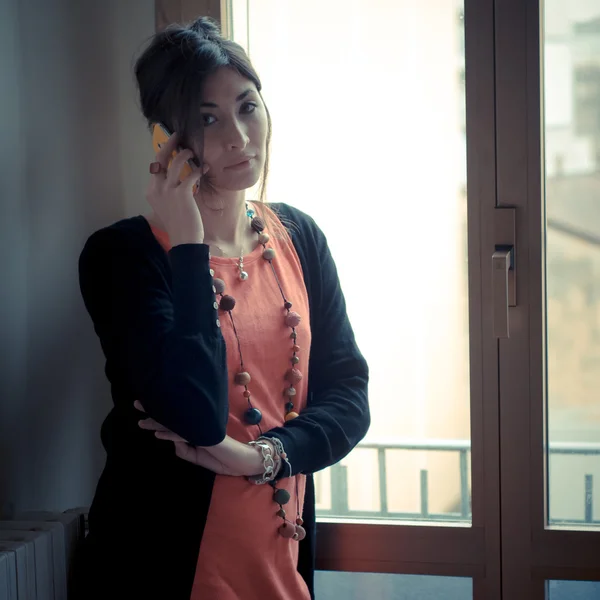 Beautiful woman at home at the phone — Stock Photo, Image