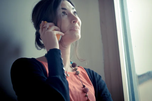 Beautiful woman at home at the phone — Stock Photo, Image